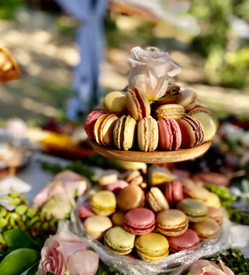 Gourmet French macarons displayed on a tiered stand for a luxury event setup serving San Dimas and surrounding areas.