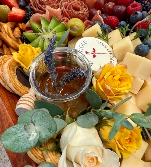 Handcrafted grazing board with honey, roses, meats, cheeses, and fruit served in Glendora and San Dimas by Rose Gold Charcuterie.