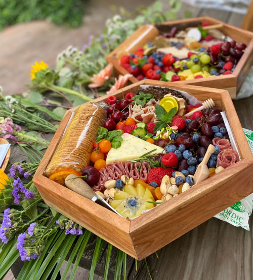 Hexagon-shaped charcuterie board loaded with premium cheeses, meats, fruits, crackers, and honey—designed for parties and celebrations in Southern California.